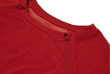 Load image into Gallery viewer, Close-up view of raglan-sleeve dress in tomato color demonstrating detailing of ribbed crew-neck trim, zipper pull covers, and fabric texture
