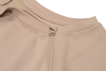 Load image into Gallery viewer, Close-up view of raglan-sleeve top in taupe demonstrating detailing of ribbed crew-neck trim, zipper pull covers, and fabric texture