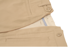 Load image into Gallery viewer, Close-up view of khaki pants to demonstrate detailing of front and rear pocket detailing and expandable side button adjustment