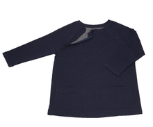 Load image into Gallery viewer, Full view of women&#39;s raglan-sleeve top in navy featuring bracelet-length sleeves, two double-welt front pockets, and one upper chest zipper in unzipped position
