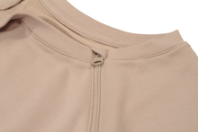 Load image into Gallery viewer, Close-up view of raglan-sleeve top in taupe demonstrating detailing of ribbed crew-neck trim, zipper pull covers, and fabric texture
